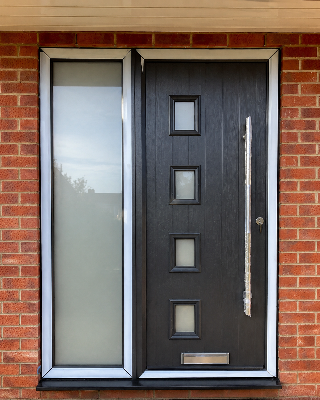 Black composite front door with glazed panels and matching sidelight